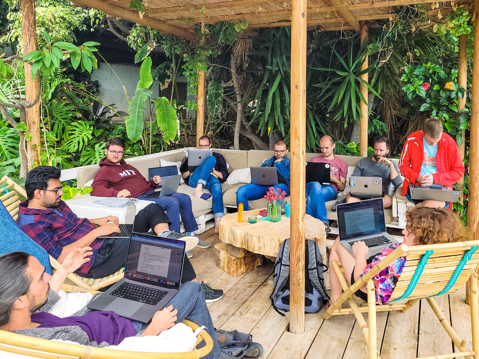 An impromptu focus group gathered next to the pool with laptops to discuss cross-team marketing strategies.