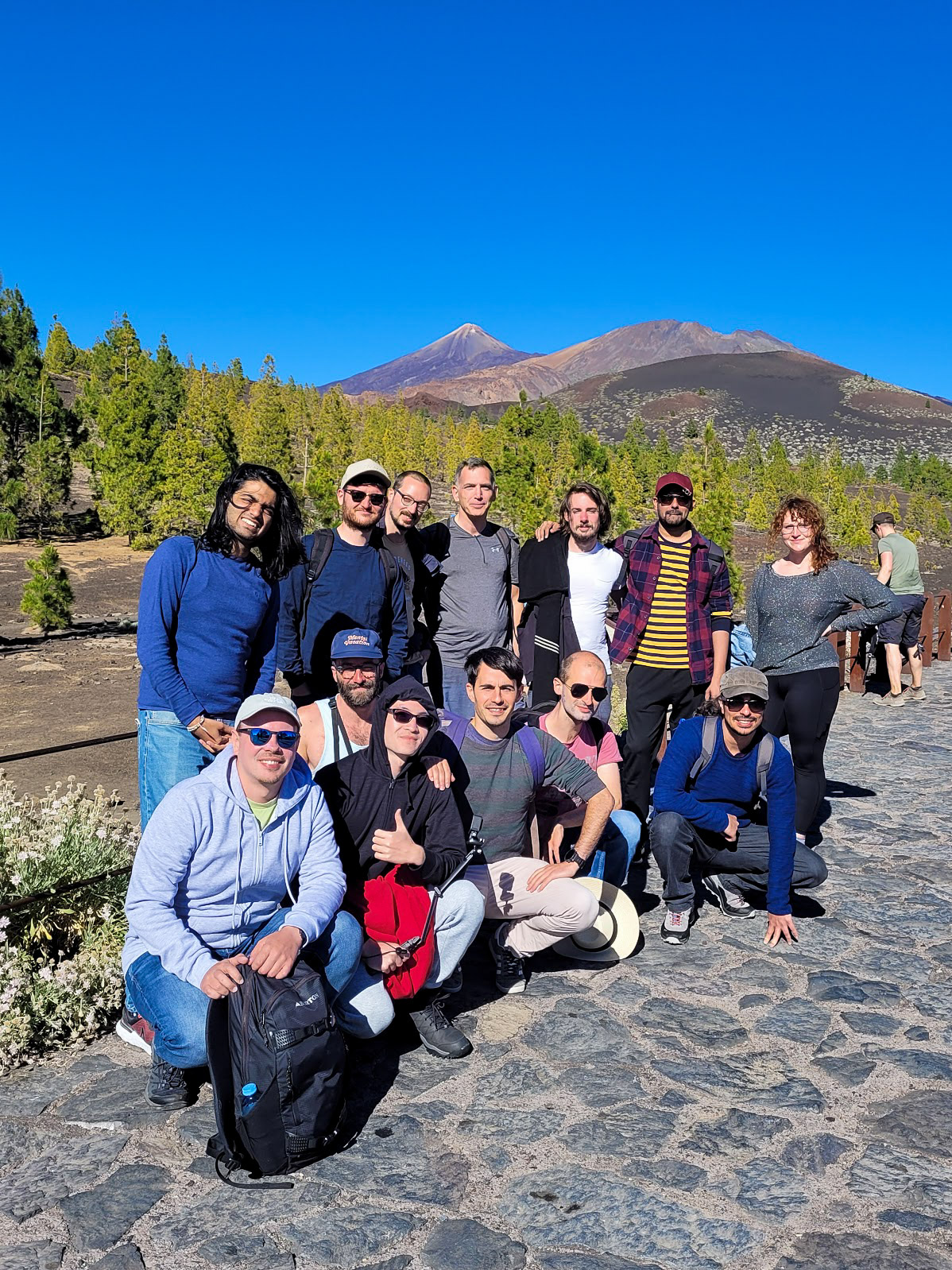 A group photo of the MUI crew posing near the base of Mount Teide at the start of the hike.