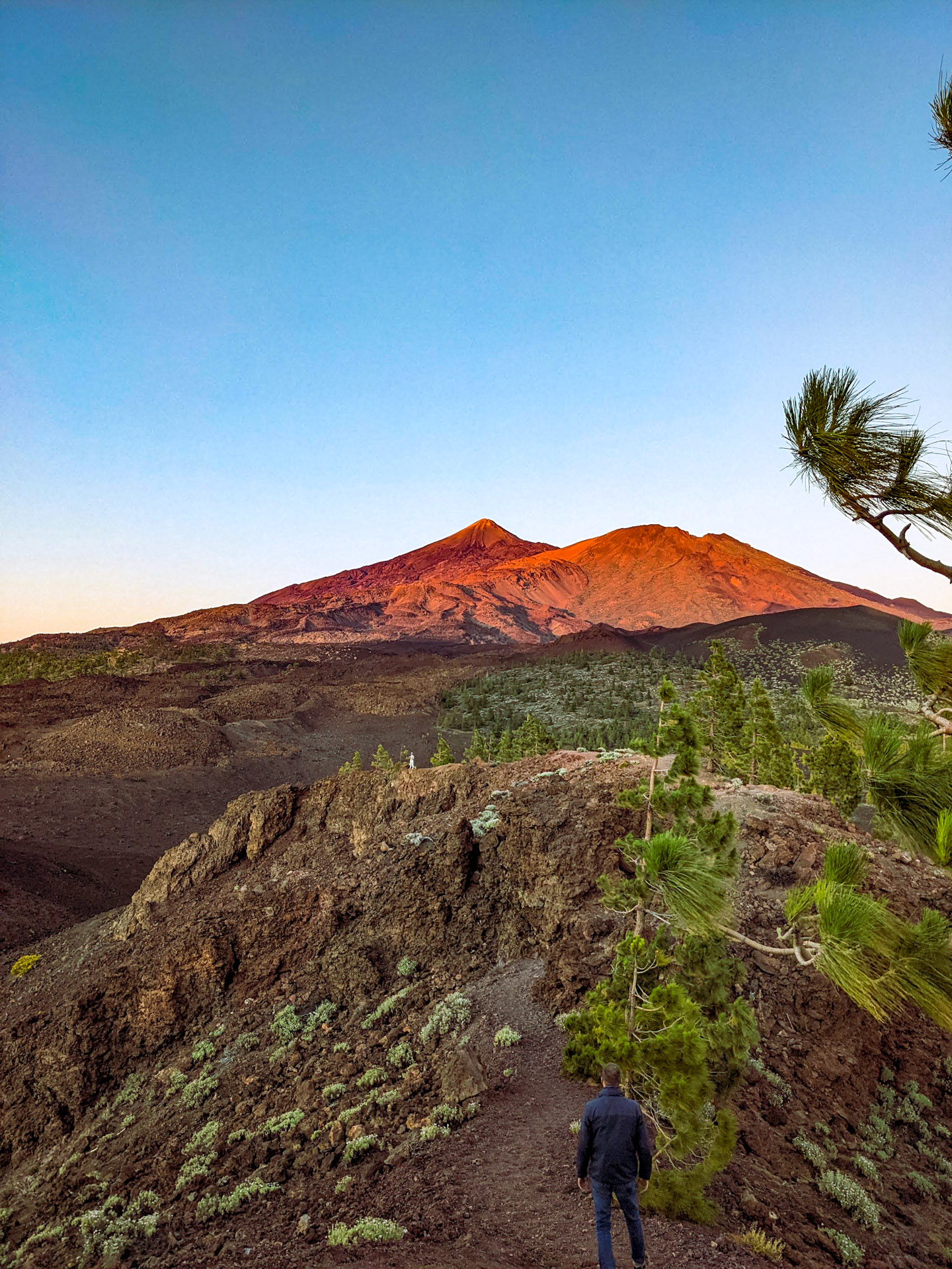The path leading down the hill from the sunset view, with Teide glowing red in the background.