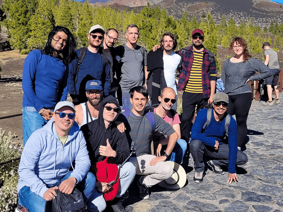 A group photo of the MUI crew posing near the base of Mount Teide at the start of the hike.